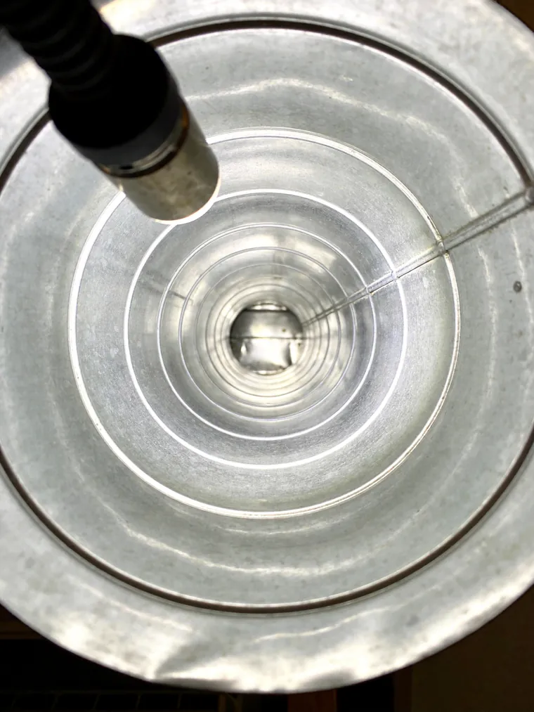 The same air duct after professional cleaning, spotless metal interior