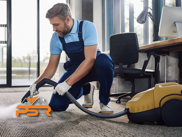 male professional technician working performing carpet cleaning services and freshening in office