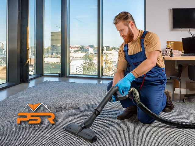 male technician professional performing carpet cleaning services in business office setting